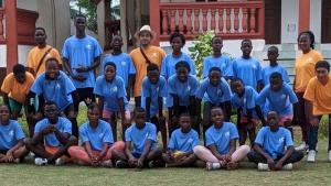 a group of children and teens outdoors with coordinating shirts