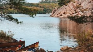 two canoes on the shore of a lake