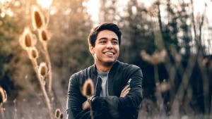 smiling man standing in a field