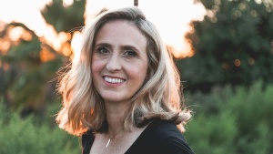 a smiling woman in an outdoor setting