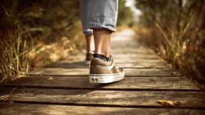 a pair of feet walking on a path