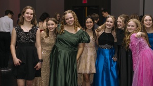 a group of teenage girls wearing prom dresses