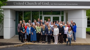 A group of people standing outside a building that says United Church of God