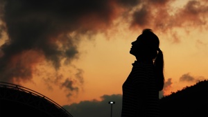 A woman looking up to the sky.