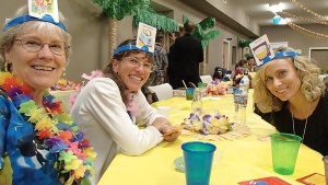 Left to right: Diane Oliver, Berenice Emehiser and Becky Oliver enjoy a game of Headbanz at the Luau.