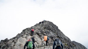 Photo of a group hiking together up a mountain.