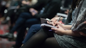 Photo of woman taking notes during church services.