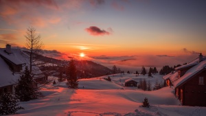 a snowy landscape at sunrise/sunset