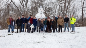 ABC students and staff pose with a snowman they made on Feb. 9.