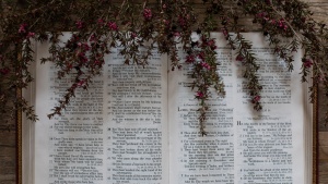 Photo of an open Bible with dried flowers laid on top.