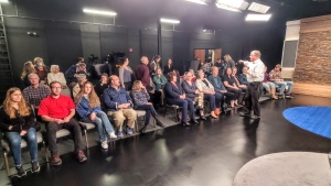 Peter Eddington arranges the studio audience before the recording of a Beyond Today television program.