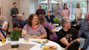 Employees and their families watch the raffle drawing after lunch.