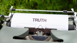 Image of a typewriter with TRUTH on the page.