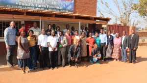 Darris and Debbie McNeely with brethren stand in front of the LifeNets Internet Cafe in Malawi.
