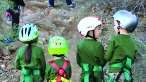 Campers getting ready to go rock climbing. 