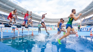 Runners racing through water obstacles.