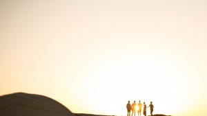 Photo of people's silhouettes at golden hour.