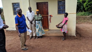 Elderly couple receiving keys to home built for them by Good Works in Chipata.