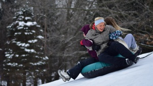 a group of girls snow tubing