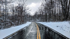 a road with a snowy landscape on either side