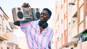 a teenager holding a vintage radio