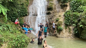 Young adults strengthened bonds during a waterfall hike.