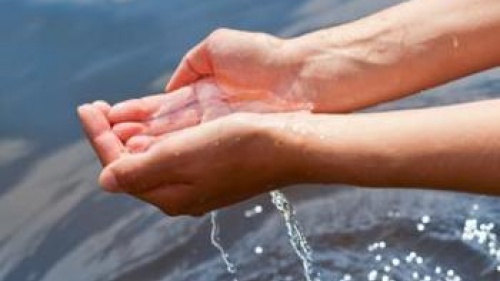 Hands holding water over more water - Understanding God's Word... What the Bible