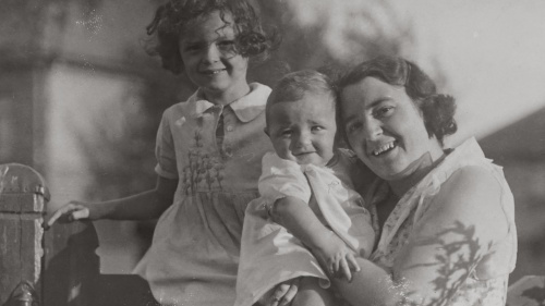 a woman and two little girls photographed in black and white