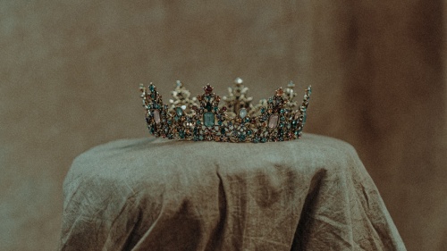 a crown sitting atop a beige cloth