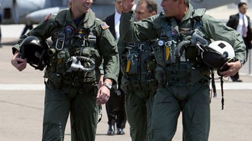 President George W. Bush walks across the tarmac with NFO Lt. Ryan Phillips.