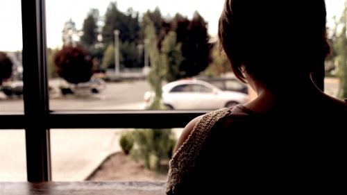 A woman looking out a window.