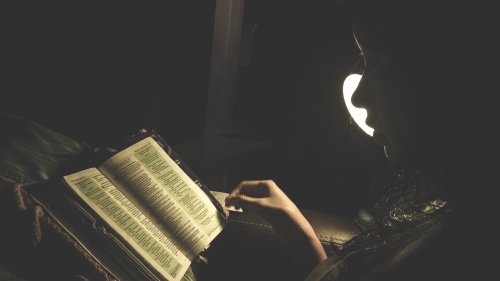 A woman reading a Bible.