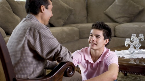 A dad and son talking.