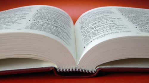 An open Bible laying on a table.