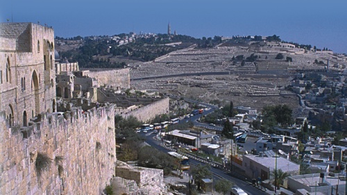 The prophet Zechariah describes how Jesus will return to the Mount of Olives (background, above), which overlooks Jerusalem (foreground) on the city’s east side.