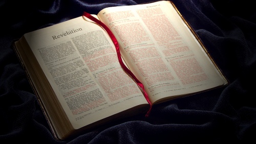 A Bible opened to the book of Revelation.