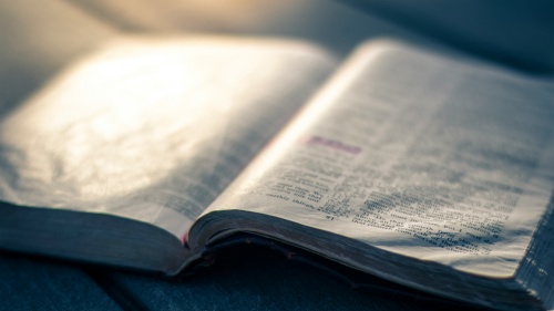 An open Bible on a table.