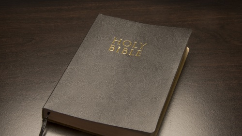Bible laying on top of a table.