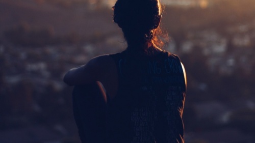 A young woman sitting by herself.