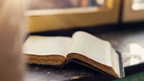 A Bible laying on a table.