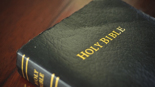 A Bible laying on a table.