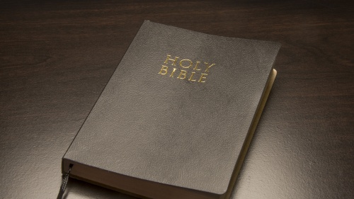 Bible laying on top of a table.