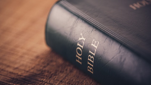 A Bible laying on a table.