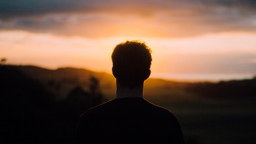 A person looking at a sunset.