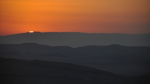 Sunset over desert hills.