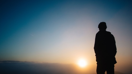 A person watching a sunset.