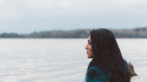 A woman looking out over a body of water.