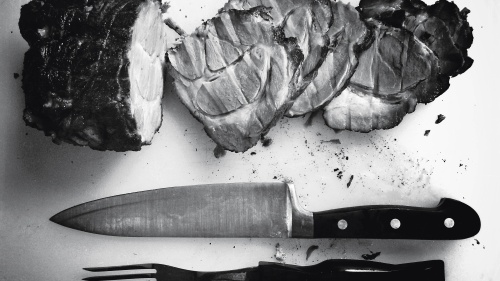 Sliced meat on chopping board