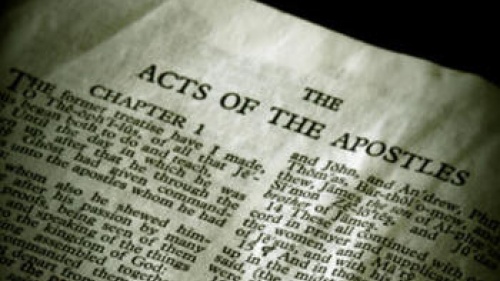 Page of the Bible opened to Acts.