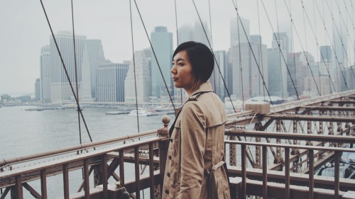 A woman walking on a bridge.